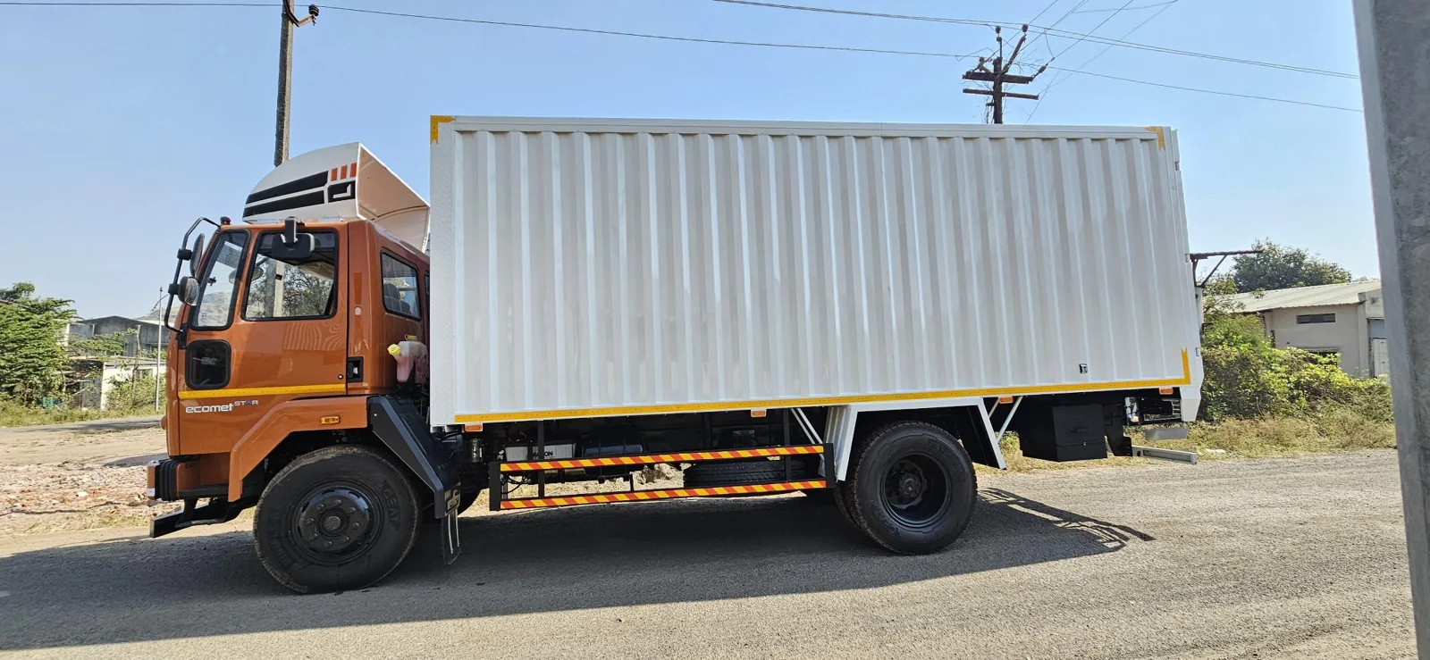 White dry cargo container body on commercial truck