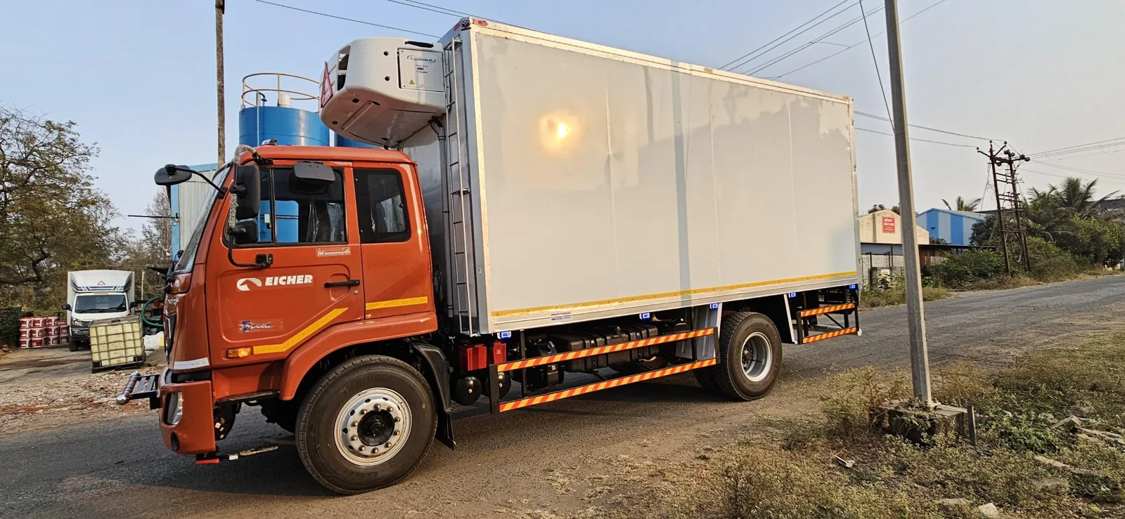 Orange commercial truck with enclosed cargo body